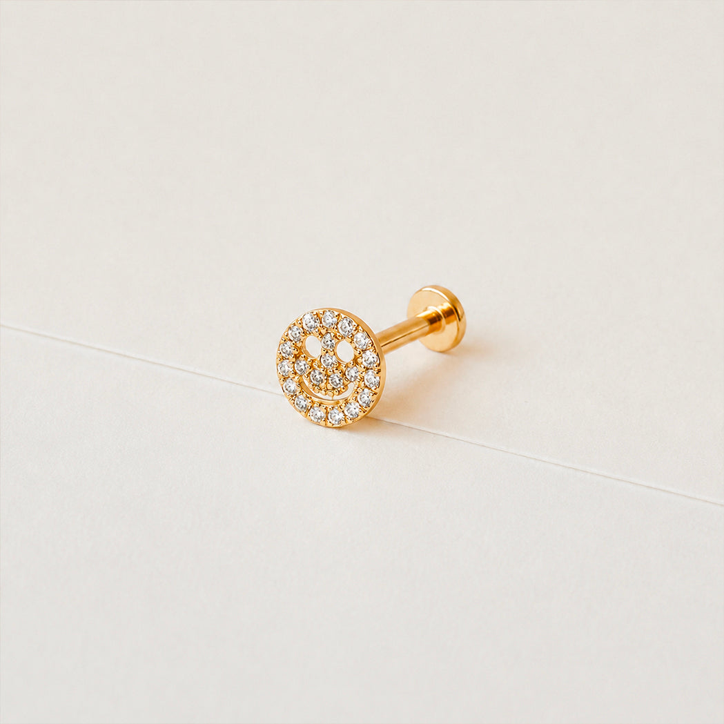 Ohrpiercing Smiley aus Gold und Diamanten